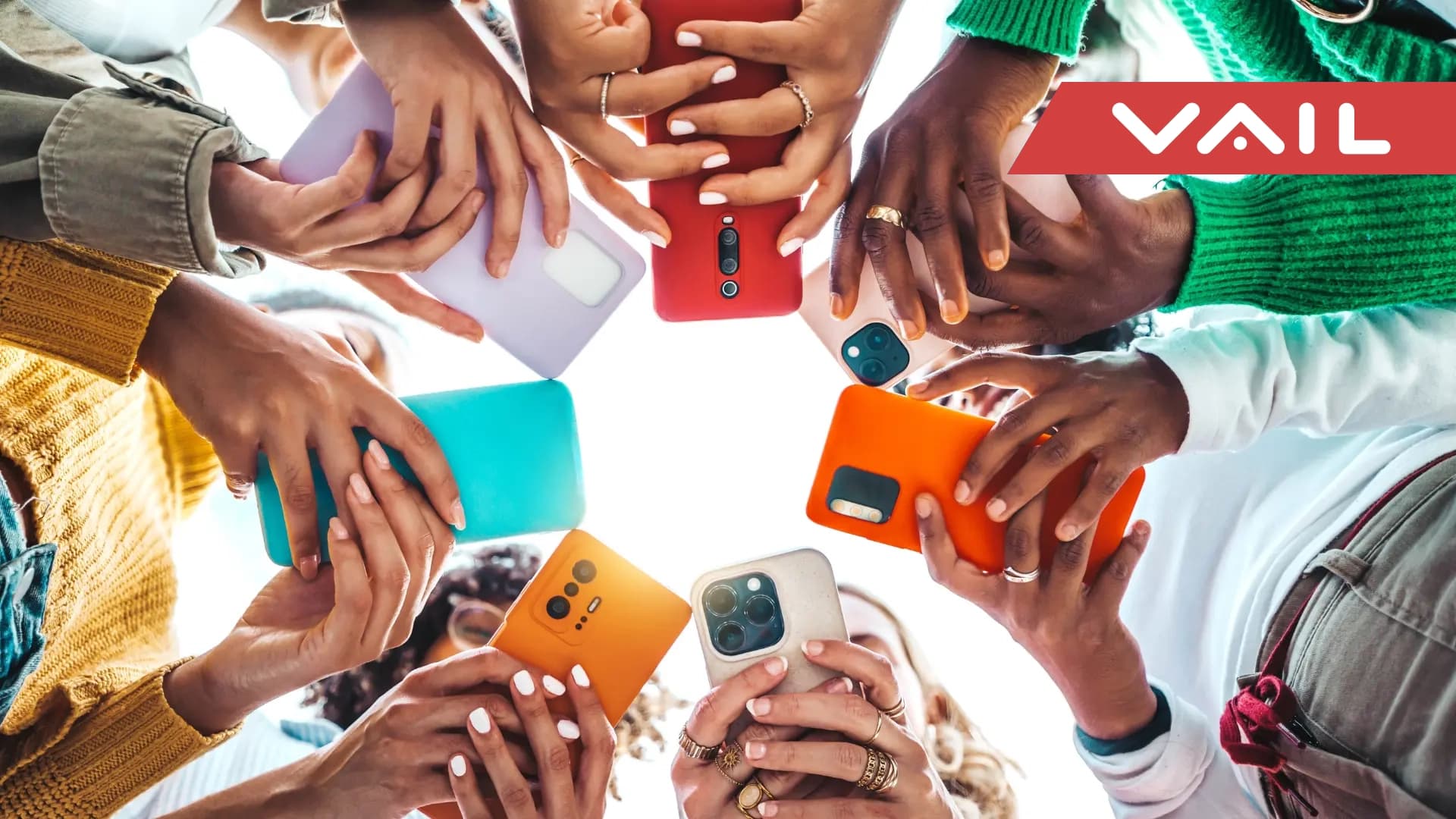 Worms eye view at a group of people standing with their cell phones out