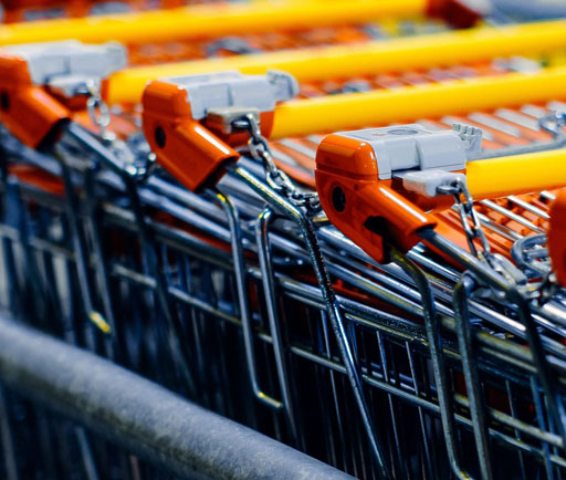 Close-up of nested shopping cart handles in a retail store